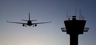 Image of Airplane and Control Tower at Dusk